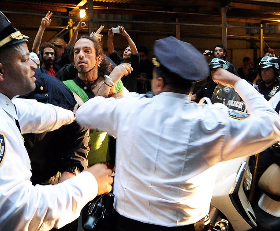NYPD Deputy Inspector Johnny Cardona (right) hits protester Felix Rivera-Pitre (green shirt), as Occupy Wall Street activists clash with police in the Financial District on Oct. 14, 2011
