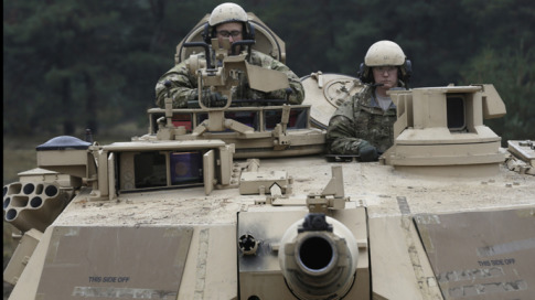 U.S. soldiers deployed in Latvia sit in an Abrams tank during a drill at Adazi military base October 14, 2014