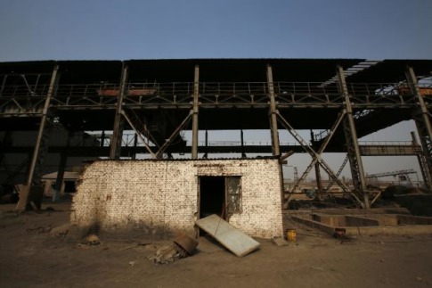 A damaged house is pictured inside an abandoned steel mill of Qingquan Steel Group in Qianying township, Hebei province February 18, 2014. Picture taken