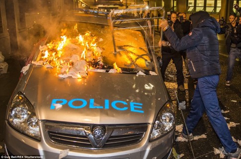 A police car was set on fire by an anti-capitalist demonstrator, who was wearing a Colmar ski jacket that cost hundreds of pounds