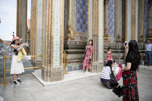 Chinese tourists at the Grand Palace in Bangkok. The wealthy parts of the city are still jammed with Thais and tourists