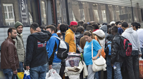 Migrants, mainly from Syria, prepare to board a train headed for Sweden, at Padborg station in southern Denmark
