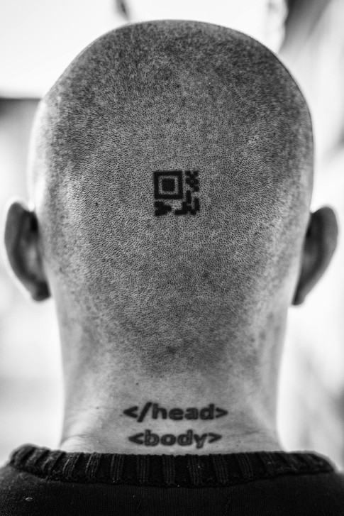 Februrary 26, 2016. Bogotá, Colombia. Details of tattoos on the back of Ándres Sepúlveda (31) head, the top tattoo he calls it his “Mayor Relic” it is a QR code encrypted in MAYA (he didn’t want to revealed what is encrypted), the second tattoo: and he got while he was drunk. Ándres Sepúlveda lives at an undisclosed maximum-security building of the General Attorneys office (Fiscalia Nacional) in Bogotá, Colombia; where he is serving a 10 years sentence for hacking and spying on the government and elected officials. Photo Credit: Juan Arredondo for Bloomberg BusinessWeek.