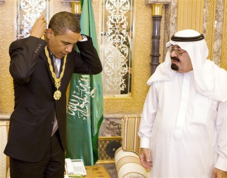 Obama receives a gift from Saudi Arabia's King Abdullah during a meeting at the king's farm outside Riyadh