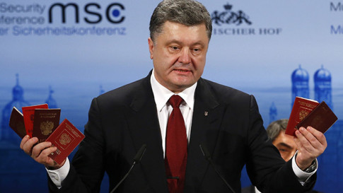 Ukraine President Petro Poroshenko holds Russian passports to prove the presence of Russian troops in Ukraine