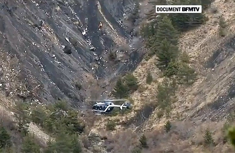 Rescue helicopter from the French Gendarmerie hovers in front of the crash site of an Airbus A320