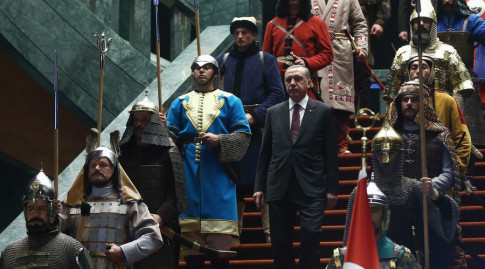 Erdogan walks down the stairs in between soldiers, wearing traditional army uniforms from the Ottoman Empire