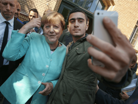 German-Chancellor-Angela-Merkel-poses-for-a-selfie-with-a-migrant-from-Syria-after-she-visited-the-AWO-Refugium-Askanierring-shelter-for-migrants